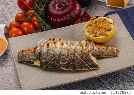 Grilled seabass fillet with lemon 113576583