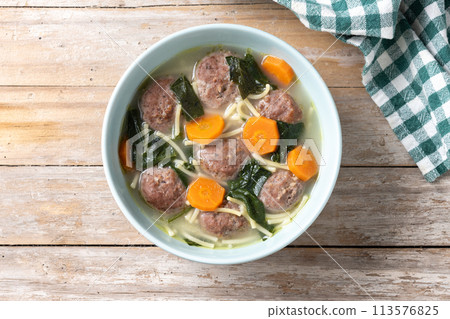 Italian Wedding Soup with meatballs and spinach on wooden table Italian Wedding Soup with meatballs and spinach on wooden table 113576825