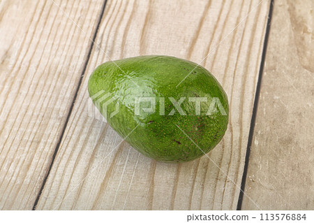 Ripe green avocado over background Ripe green avocado over background 113576884