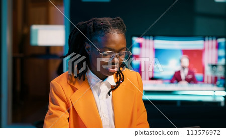 African american student working on her bachelor paper essay at home, writing ideas from online research. Girl exploring digital libraries and academic databases for additional resources. Camera A. African american student working on her bachelor paper essay at home, writing ideas from online research. Girl exploring digital libraries and academic databases for additional resources. Camera A. 113576972