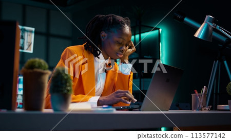 Exhausted student being stressed about project deadline, feeling distraught about late night workload. Tired young woman solving tasks with tension and anxiety, feeling sleepy and in pain. Camera B. 113577142