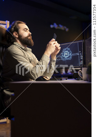 Software engineer inserting disk into PC containing language data models able to create AI. System administrator placing cartridge in computer with machine learning awakening artificial intelligence 113577354