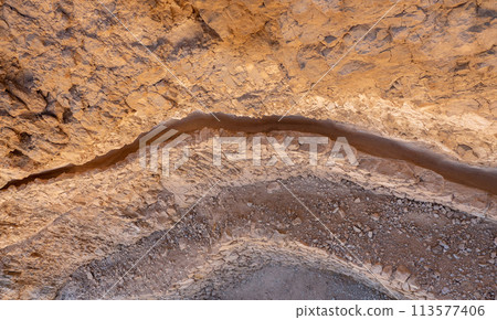 Ancient water drain in the rock. Masada fortress. Dead Sea, Jordan. Ancient water drain in the rock. Masada fortress. Dead Sea, Jordan. 113577406