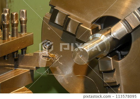 The turning machine operation with continue chip from turning process. The turning machine operation with continue chip from turning process. 113578095