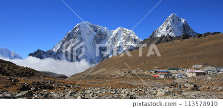 Huts in Lobuche and snow covered mountains Tobuche, Taboche and Cholatse, Nepal. 113578910