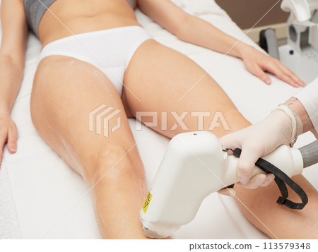 Beautician Removing Hair Of Young Woman body 113579348