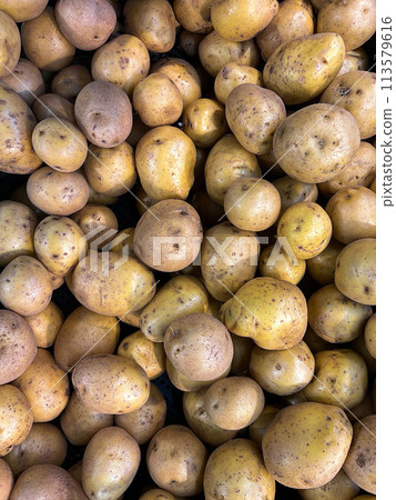 stack of raw potatoes in plastic container in market. Top view stack of raw potatoes in plastic container in market. Top view 113579616