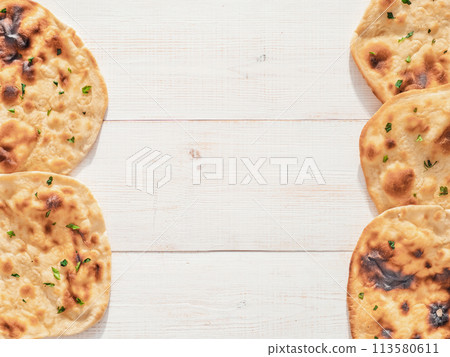 naan flatbread on white wood, copy space, top view 113580611