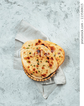 naan flatbreads on gray cement, copyspace vertical naan flatbreads on gray cement, copyspace vertical 113580615