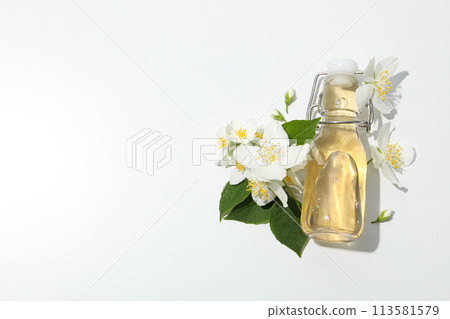 Jasmine flowers and glass bottle on white background, space for text 113581579