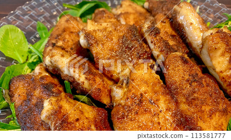 Spicy curry grilled chicken wings 113581777