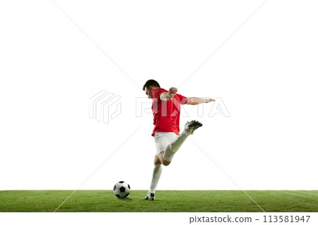 Focused and competitive young male soccer player in motion during football game on field, hitting ball isolated on white background Focused and competitive young male soccer player in motion during football game on field, hitting ball isolated on white background 113581947