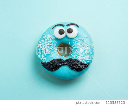 Blue glazed donut with mustache flying Blue glazed donut with mustache flying 113582323