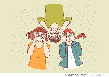 Young people lie on grass on summer lawn and make funny glasses out of fingers with smile, top view Young people lie on grass on summer lawn and make funny glasses out of fingers with smile, top view 113585155