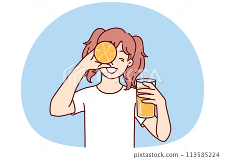 Little girl with glass of orange juice in hands smiling holding half of citrus fruit near face 113585224