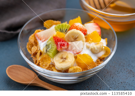 Breakfast cereal with yogurt and fruit on a dining table 113585410