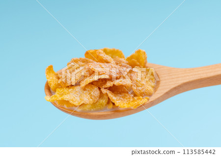 Cereal and milk on wooden spoons Cereal and milk on wooden spoons 113585442