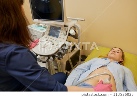 Gynecologist making ultrasonic diagnostic test for patient Gynecologist making ultrasonic diagnostic test for patient 113586023