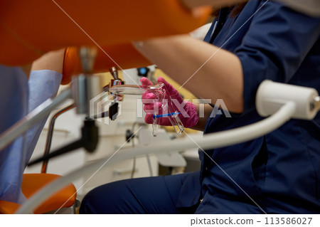 Closeup doctor gynecologist hand with professional sterile tools for examination 113586027