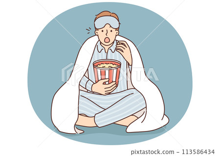 Man in pajama eat popcorn watch movie Man in pajama eat popcorn watch movie 113586434