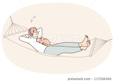 Guy lying with cat in hammock listen to music Guy lying with cat in hammock listen to music 113586480