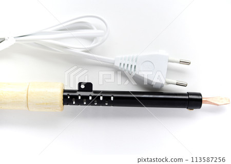 Electric soldering iron with a wooden handle on a white background. A tool for soldering radio components. 113587256