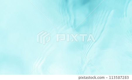 Freeze motion of splashing water surface on light blue background 113587283