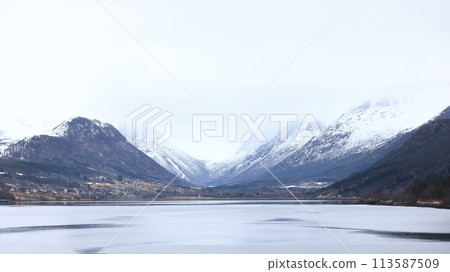 The view from the Andalsnes waterfront looking towards Isfjorden, Norway.  Isfjorden is a small village in the Rauma Valley on the shores of Romsdalsfjord. 113587509