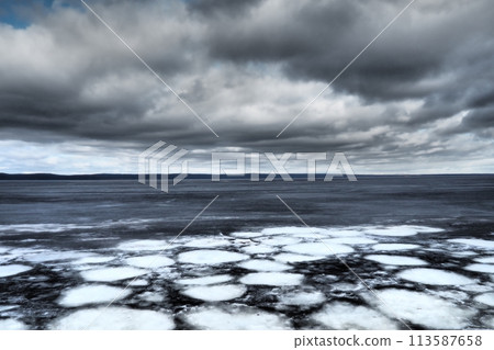 Ice drift in spring on Lake Onega, Karelia. Dangerous thin spring ice in April. Aggregate accumulations of fine-crystalline grains. Opening of small lakes, ponds and reservoirs. Crushed ice floes 113587658