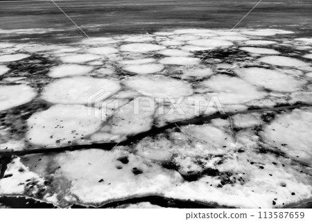 Ice drift in spring on Lake Onega, Karelia. Dangerous thin spring ice in April. Aggregate accumulations of fine-crystalline grains. Opening of small lakes, ponds and reservoirs. Crushed ice floes 113587659