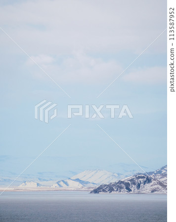 snow-covered mountains in distance and coldness sea snow-covered mountains in distance and coldness sea 113587952