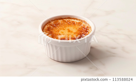 Creme brulee served in a classic ramekin, combination of creamy custard and caramelized sugar 113588024