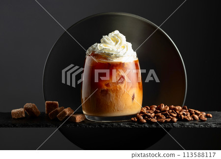 Iced coffee with whipped cream and caramel sauce. 113588117