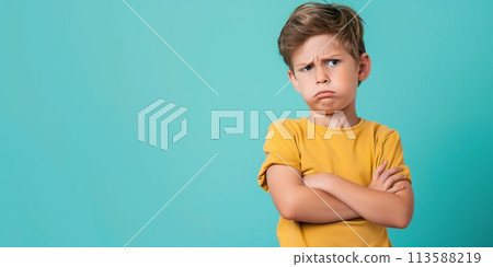 Determined boy with crossed arms on blue 113588219