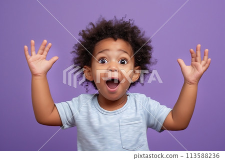 Excited child with arms up and mouth open 113588236