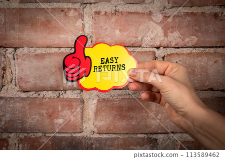 Easy Returns. Sticky note with text on a red brick background 113589462