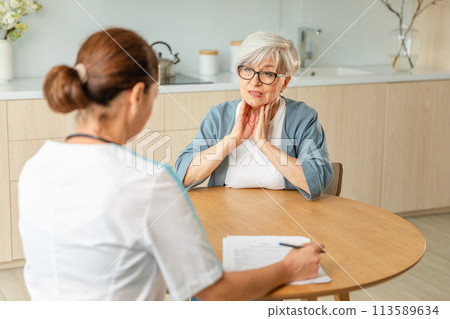 Female doctor examining older senior woman in doctor office or at home. Old woman lady patient and doctor have consultation in hospital room. Medicine healthcare medical checkup. Visit to doctor Female doctor examining older senior woman in doctor office or at home. Old woman lady patient and doctor have consultation in hospital room. Medicine healthcare medical checkup. Visit to doctor 113589634