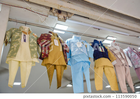 Traditional Kurtas in different colors for children in street markets of Jaipur 113590050