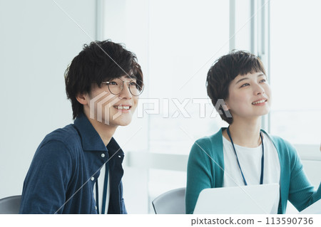 Young men and women working on computers 113590736