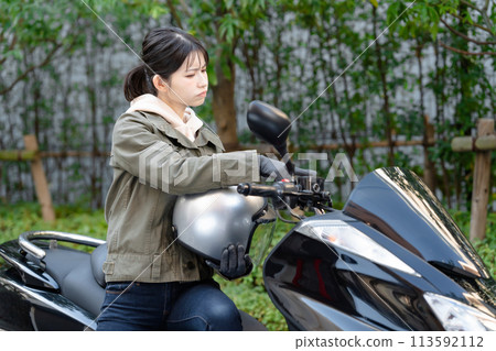 A woman who is worried while riding a bike A woman who is worried while riding a bike 113592112