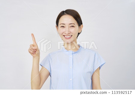 Woman pointing to the left on white background Woman pointing to the left on white background 113592517