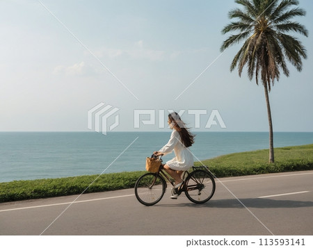 Woman cycling on the beach 113593141