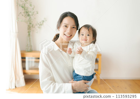 Mom holding a baby 113593295