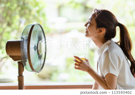 A girl cool with a fan A girl cool with a fan 113593402