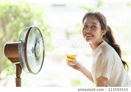 A girl cool with a fan A girl cool with a fan 113593413