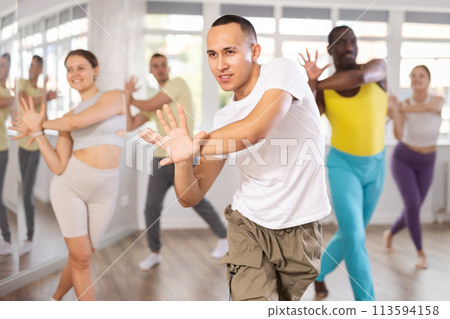Young Asian male instructor leading modern dance class 113594158