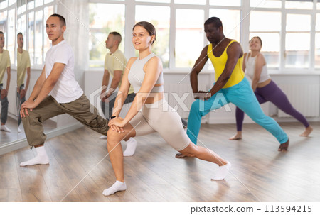 European girl with team of like-minded multinational people learn to elements of electro dance 113594215