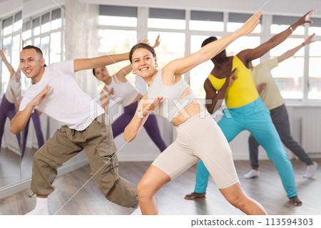 European girl with team of like-minded multinational people learn to elements of electro dance 113594303