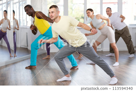 Young man practicing hip-hop dance in training hall 113594340