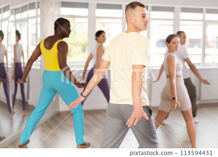 Young man practicing aerobic dance in training hall 113594431